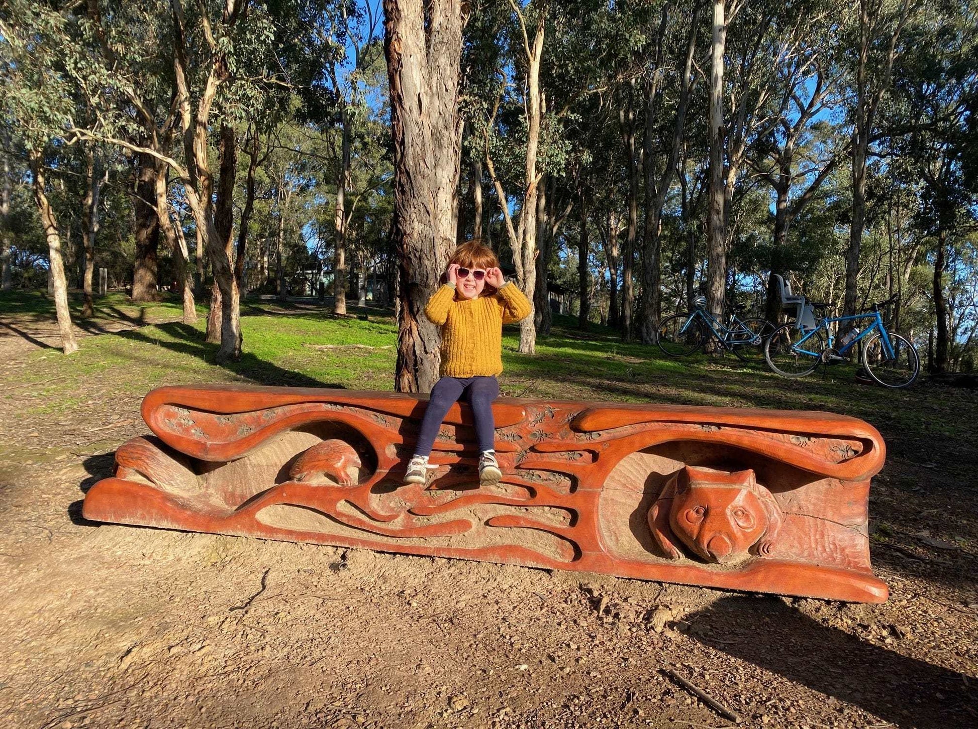 Sitting on big sculpture at Bush Park