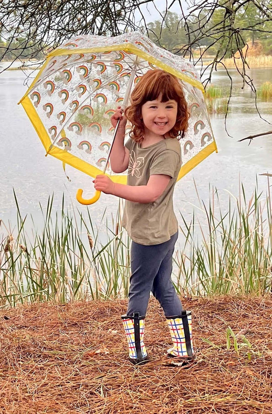 Girl with umbrella looking over the lake