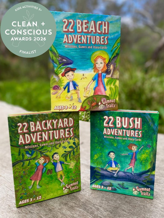 Three children's books titled '22 Beach Adventures', '22 Backyard Adventures', and '22 Bush Adventures' on a wooden surface with a natural background.