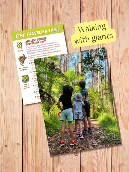 Children on a forest trail with a 'Time Traveller Tales' scavenger hunt sheet on a wooden surface. Gumnut Trails mission