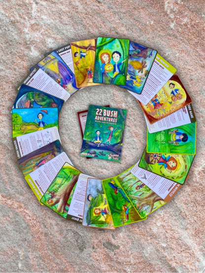 Circular arrangement of children's story cards and adventure cards on a textured surface from Gumnut Trails Bush Guide.
