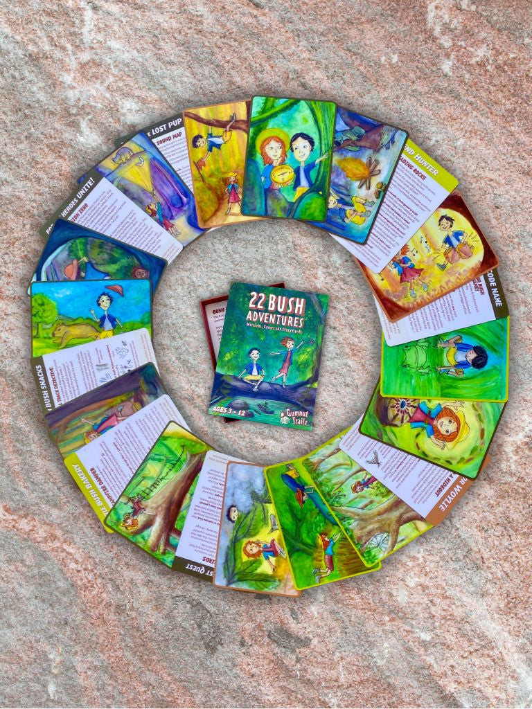 Circular arrangement of children's books on a textured surface from Gumnut Trails Bush Guide.