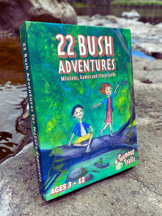 Book titled '22 Bush Adventures' on a rocky surface. Gumnut Trails Bush Guide.