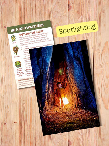 Wooden surface with a photo of a person in a dark forest and a card titled 'The Nightwatchers'. Gumnut Trails Guides