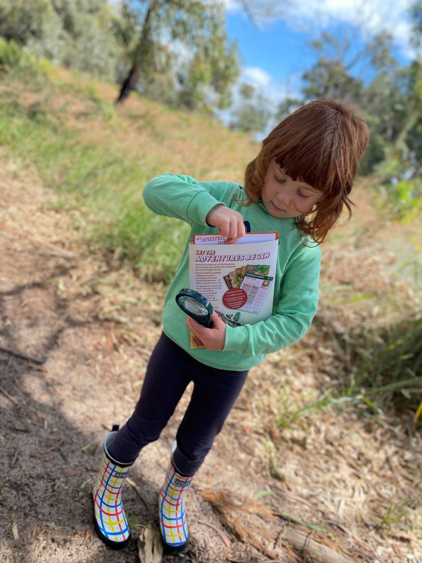 Child reaching into Adventure Guides